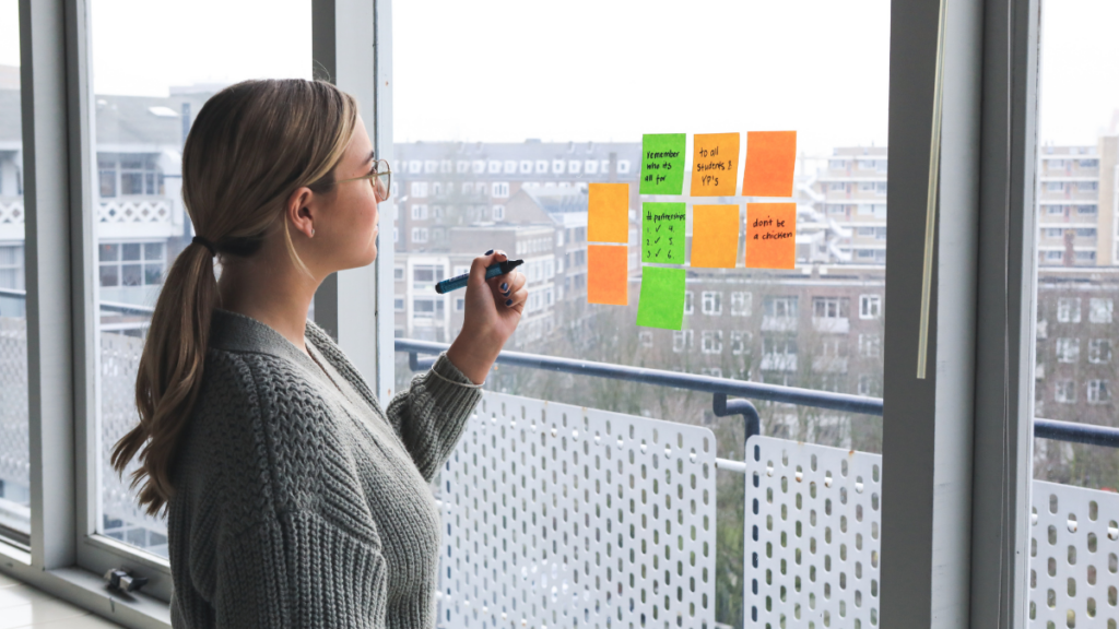 a woman making post-it notes